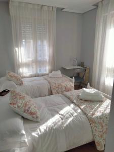 a bedroom with two beds and a desk at GRAN FAMILIA in Santander +31 photos
