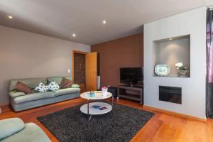 ein Wohnzimmer mit Sofa und Tisch in der Unterkunft Moledo - Listening the Waves in Moledo