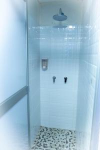 a bathroom with a shower with a glass door at Casa Kutimuy in Ayacucho