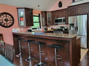 a kitchen with a center island with bar stools at Crescent Lakehouse - Surf, Ski and Serenity in Iron River