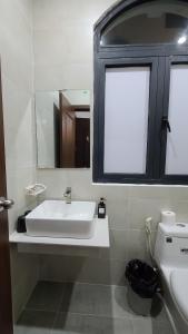 a bathroom with a sink and a mirror and a toilet at Xan hotel in Phú Quốc +25 photos
