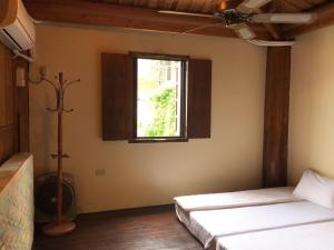 Postel nebo postele na pokoji v ubytování Jin Sha Ting Hai Homestay I