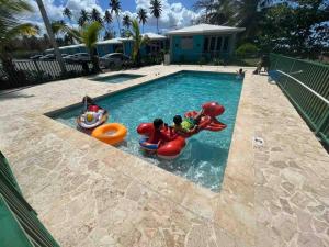 a swimming pool with some inflatable toys in it at VILLA SEA BEACH in Aguada