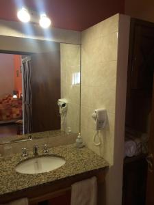 a bathroom with a sink and a mirror at Samai Mayu in Los Reartes