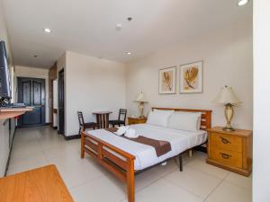 Voodi või voodid majutusasutuse Main Hotel & Suites toas