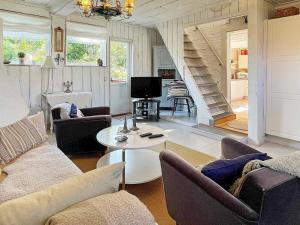 a living room with a couch and a table at Holiday home ELLÖS IX in Ellös