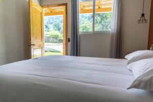 a bedroom with a large white bed and a window at Casa Montana Hotel in Chichicastenango