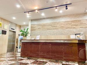 a hotel lobby with a reception counter and a wall at Traveler Hotel Taitung in Taitung City