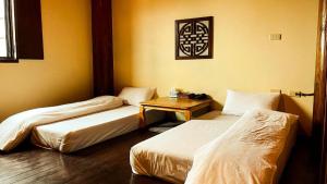 Postel nebo postele na pokoji v ubytování Jin Sha Ting Hai Homestay I
