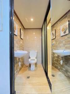 a bathroom with two sinks and a toilet at Palompon kalimba de luna Villa Inn in Leyte