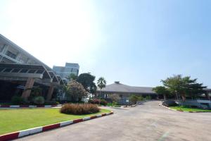 an empty street in front of a building at Uniland Golf & Resort in Nakhon Pathom