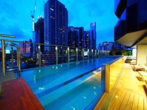a swimming pool on top of a building with a city skyline at 1 Bedroom Modern Apartment Near Crown and CBD in Melbourne