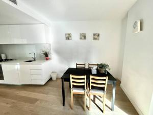 a kitchen with a dining room table and chairs at 1 Bedroom Modern Apartment Near Crown and CBD in Melbourne