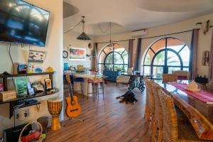 a living room with a table and a dining room with guitars at Casa Kootenay Waterfront Bnb in La Paz
