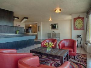 a waiting room with red chairs and a table at Inn at the Convention Center in Portland