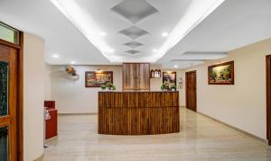 a lobby with a reception desk in a building at Treebo Trend Majestic Palms 2 Km From Colva Beach in Benaulim