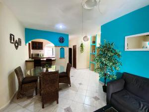 a living room with a table and a blue wall at Apartment w/ PRIME location Mexican Colonial style in Playa del Carmen