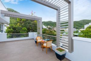 a balcony with a table and chairs and a large window at Palm Villa 39 - Luxury Free Bida & Karaoke in Vung Tau