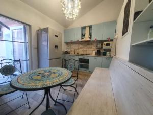 a kitchen with a table and chairs and a refrigerator at Solaria House in Constanţa +53 photos