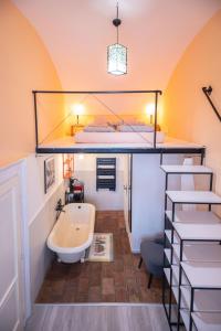 a bathroom with a bunk bed and a tub and a sink at MOOKI Rumbach Budapest Apartment in Budapest