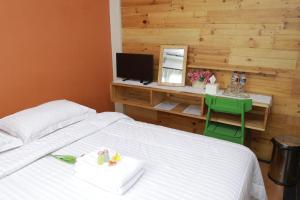 a bedroom with a bed and a desk with a computer at Roemah 28 Syariah in Medan +103 photos