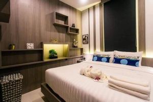 Voodi või voodid majutusasutuse Nut & Non Pool Villa by Duangtham toas