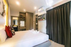 Voodi või voodid majutusasutuse Nut & Non Pool Villa by Duangtham toas