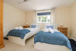 a bedroom with two beds and a window at 9 Copes Gardens in Truro
