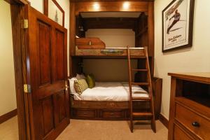 a bunk bed room with a bunk bed with a ladder at Flagstaff Two Bedroom apartment hotel in Park City