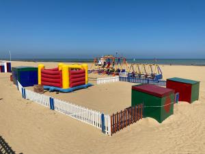 a group of playground equipment on a beach at Palm Bay Apartment in Margate