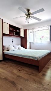 a bedroom with a large bed with a ceiling fan at Holiday Home Jaga in Biograd na Moru +29 photos