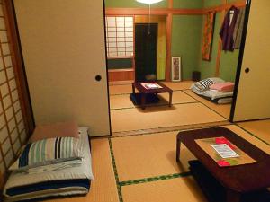 Postel nebo postele na pokoji v ubytování Aoshima Guesthouse Hooju