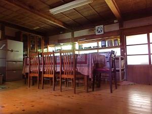 a dining room with a table and some chairs at Kominka Sharehouse Hooju in Miyazaki