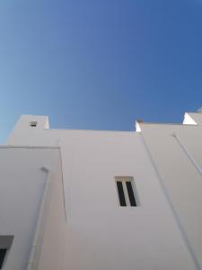 a white building with a window on the side of it at Casa Paola in Cutrofiano