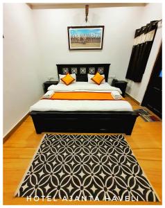 a bedroom with a bed with a black and orange comforter at Hotel Ajanta Haveli in Jaisalmer