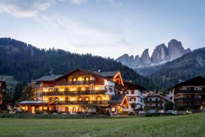 a large building in the middle of a mountain at Garnì Letizia in Campitello di Fassa