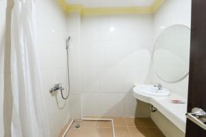 a bathroom with a shower and a sink at RedDoorz at Brother Homestay Kupang in Kupang