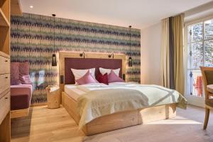 Postel nebo postele na pokoji v ubytování Dolomit Boutique Hotel