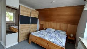 a bedroom with a bed and a wooden wall at Schippkieker in Heikendorf