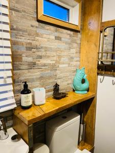 a bathroom with a wooden counter above a toilet at 30 Granada in Selsey