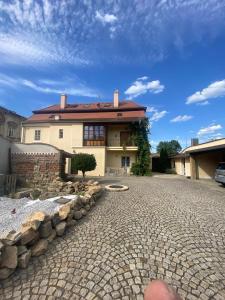 a house with a brick driveway in front of it at Apartmány Vila Lucia 1 in Plzeň