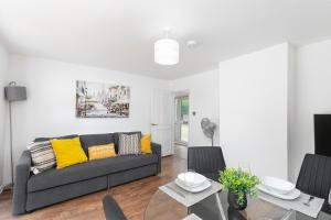 a living room with a couch and a table at Skyvillion - STEVENAGE SPACIOUS COMFY 2BED HOUSE with Garden, Free WiFi & Parking in Shephall