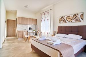 a bedroom with a large bed with towels on it at Adele Apartment in Kissamos +7 photos
