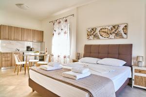 a bedroom with a large bed with towels on it at Adele Apartment in Kissamos