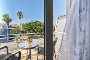 a table with a bowl of fruit on a balcony at Adele Apartment in Kissamos