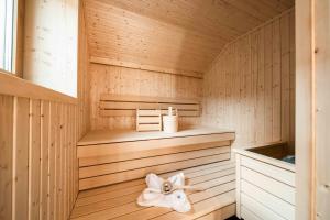 a sauna with a white towel on a shelf at Hohe Tauern Lofts Panoramabahn by Alpina-Holiday in Dorf