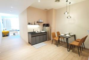 a kitchen and dining room with a table and chairs at The Peak - Bangsar South Mid Valley in Kuala Lumpur