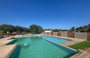 a swimming pool with a clear blue water at TRA MANNA in Lecci +12 photos