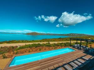 a swimming pool with a view of a lake at Shark Bay Hotel & Spa in Langebaan
