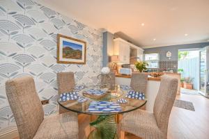 a dining room with a glass table and chairs at Lisburne Place - Luxury Three Bedroom Town House in Torquay